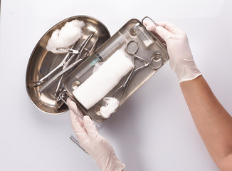 Dental appliances in sterile packaging. Dentist's hand in gloves