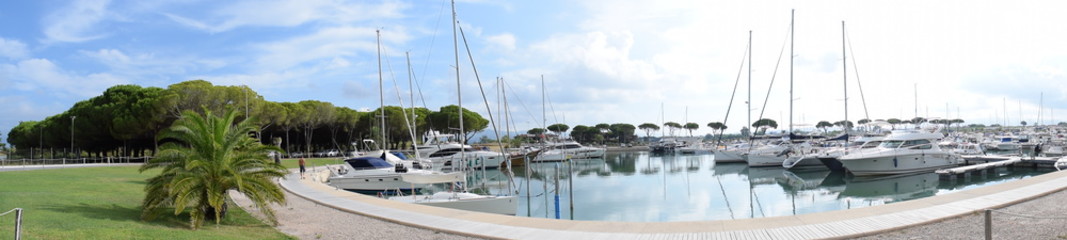 Fototapeta na wymiar Cecina, Italy - August 17, 2020: The harbor of Marina di Cecina. Boats inside the port in a summer day.