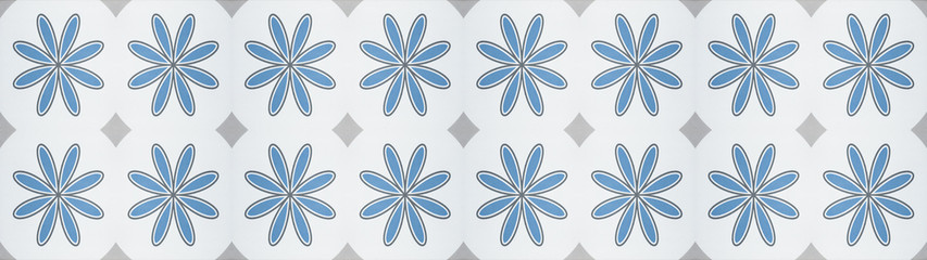 Seamless vintage retro blue, white, gray tiles mosaic texture background wide panorama banner wallpaper, with flower diamond lozenge motif print tile