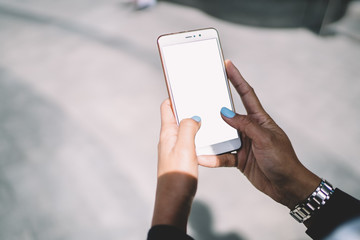 Woman surfing cellphone in street