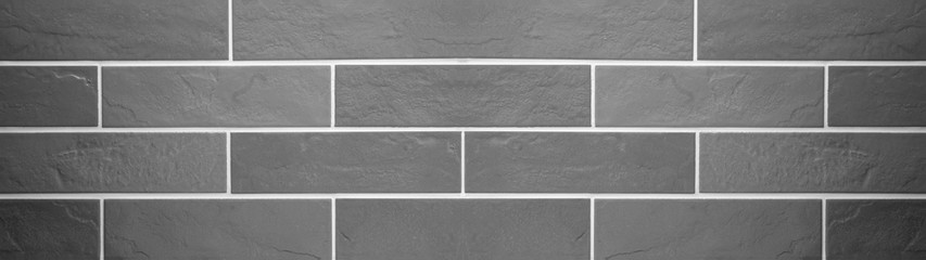 Gray grey brick tiles wall texture wide background banner panorama	