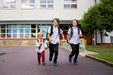 Obraz premium School children, boys, going back to school after the summer vacation