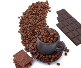 Cup with coffee beans and scattered coffee beans with chocolate isolated on white