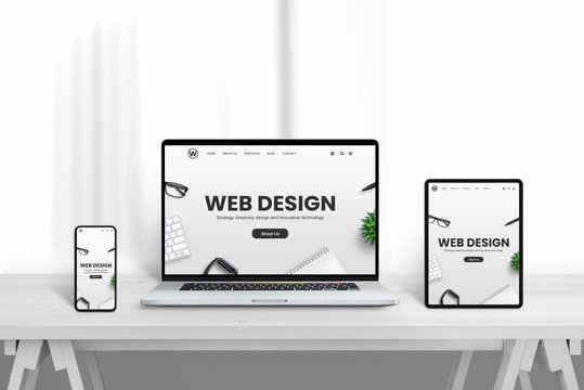 Web design company web site promotion od different devices. White wooden desk with clean background