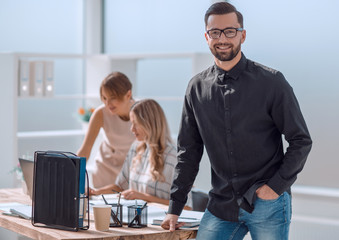 smiling young business man standing in office