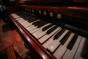 Fototapeta na wymiar Old vintage harmonium piano keyboard. Close up view
