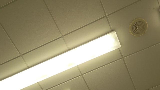 White plastic tiled clinic operating room ceiling lighting rotating strangely slow motion