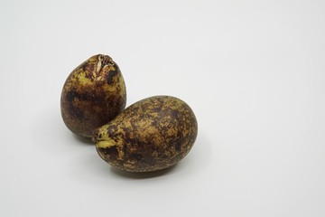 Couple of matoa fruit from Papua, Indonesia close up and macro photo with a white background