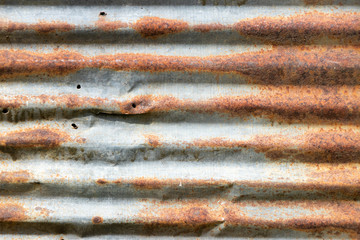 Grunge silver and red rust corrugated iron metal plate textured background