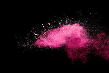 Pink powder explosion on black background. Paint Holi.