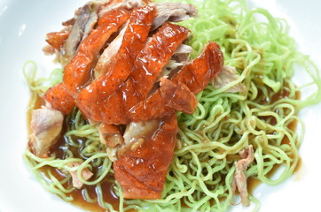 Chinese jade noodles topping slice roasted duck dressing sweet soy sauce on plate