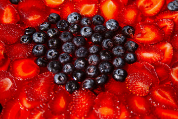 Delicious raspberry cake with fresh strawberries, raspberries, blueberry background