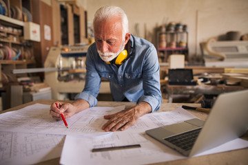 Construction engineer working hard on a project blueprint