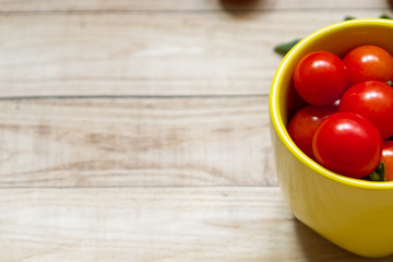 cherry tomatoes on wooden table background