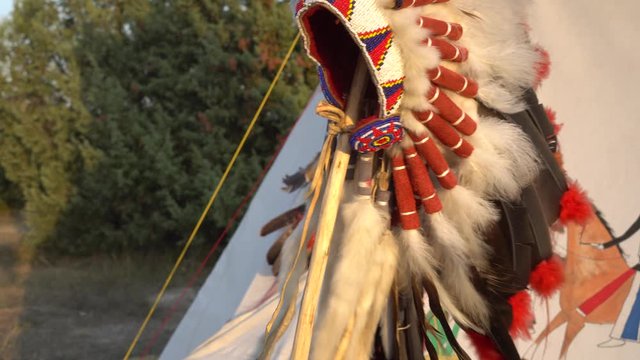 Native American Indian Headdresses and Clothing. Navajo Leather Shield with Feathers.  Bow and arrows