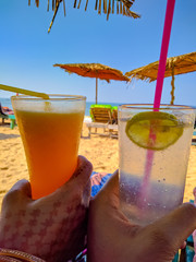 captured glass of beverages on the beach at Candolim beach Goa with mobile camera