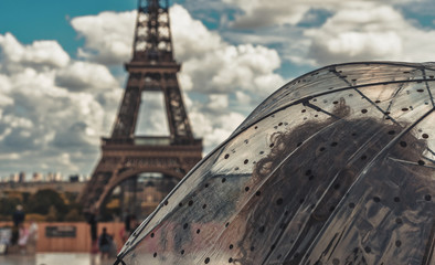 Woman with umbrella watching the Eiffel tower