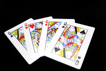 Four Queens in a row - Playing Cards, Isolated on black