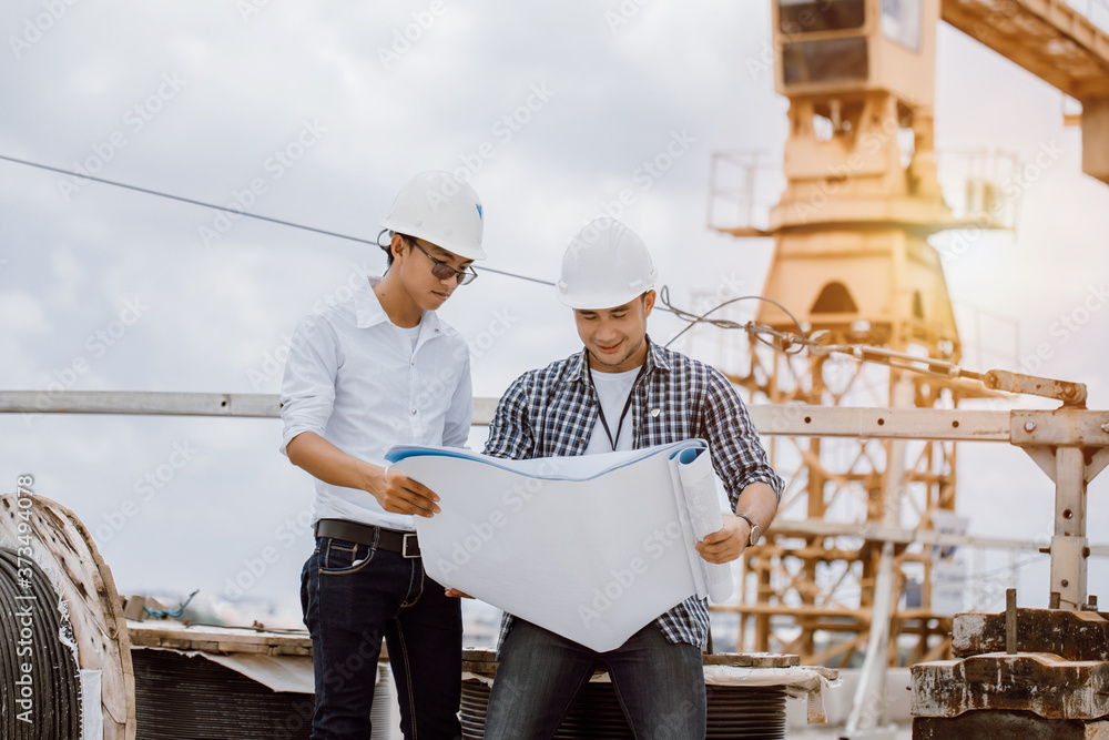 Aufkleber construction engineer checking plan on construction site for new infrastructure project. engineering