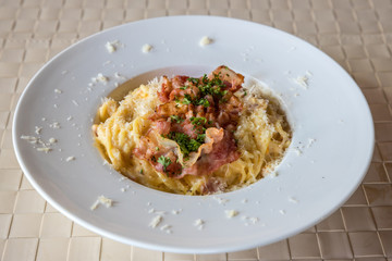 Spaghetti Carbonara on wooden table. Classic homemade carbonara pasta with pancetta.  Carbonara pasta, spaghetti with bacon,egg,cheese. 