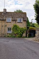Fototapeta na wymiar Pretty Cotswold stone cottages in the Cotswold village of Burford in Oxfordshire - United Kingdom