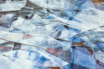 Background of broken glass on the floor in blue tones