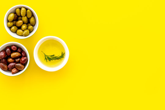 Olive Oil In Bowl Near Oilves On Yellow Desk From Above Copy Space