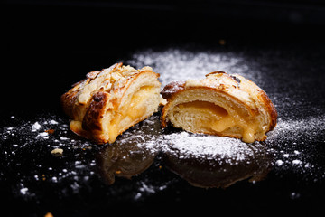 Croissants with filling. Homemade pastries, croissants cut in half and sprinkled with icing.