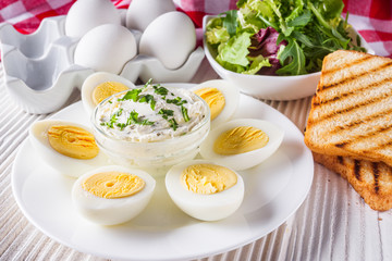 boiled chicken eggs on a white wooden rustic background