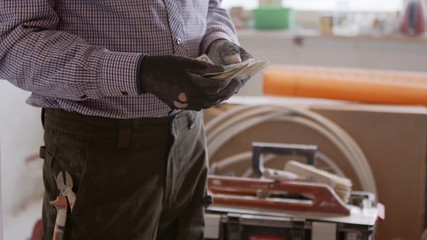 Handy man counting the money after repair. High quality photo