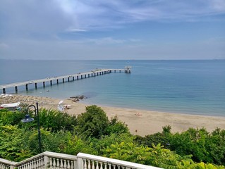 Obraz premium Beautiful view of the blue sea and the sand beach from the pier