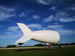 White Blimp against blue sky 