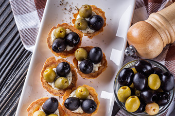 delicious snack tartlets on rustic wooden background