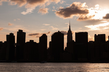Beautiful Silhouettes of Skyscrapers in the Midtown Manhattan Skyline during a Sunset over the East River in New York City