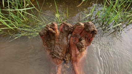 Wet mud on the soles of the feet in the river