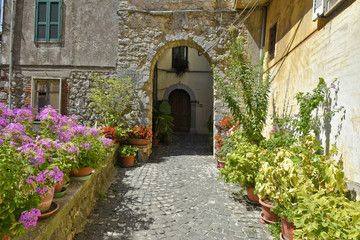 Plakat A narrow street among the old houses of Vallecorsa, a medieval village in the lazio region.