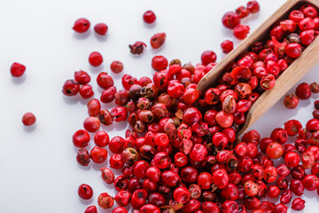 fragrant pink peppercorns on white acrylic background