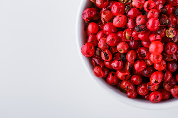 fragrant pink peppercorns on white acrylic background