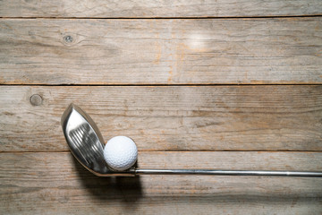golf ball and golf club on wooden table background