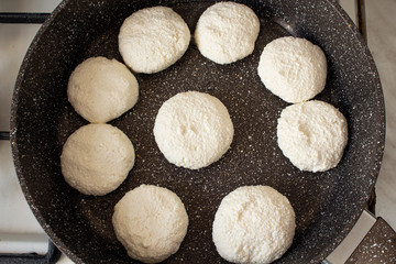 Fototapeta na wymiar Cooking process. Cheese pancakes in a frying pan