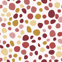 Fototapeta na wymiar Seamless isolated circle spot geometric pattern. Red, maroon, yellow, ocher color shapes on white background.