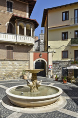 Fototapeta na wymiar A fountain in the small square among the old houses of Lenola, a medieval village in the Lazio region.