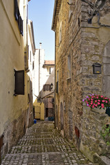 Fototapeta na wymiar A narrow street among the old houses of Lenola, a medieval village in the Lazio region.