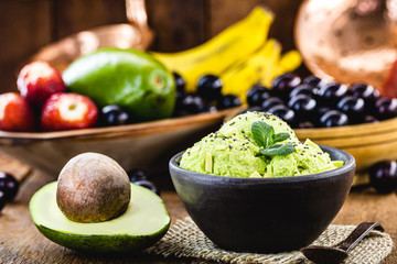 natural avocado ice cream, without preservatives, with tropical fruits from brazil in the background.