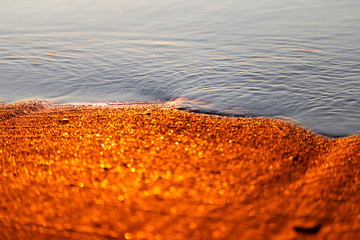 Shining golden sand and water