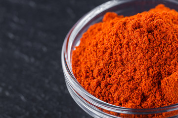aromatic ground paprika on a dark stone background