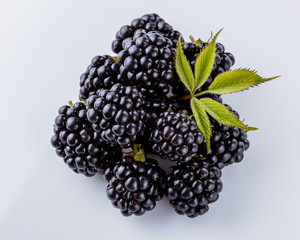 juicy blackberries on a white acrylic background