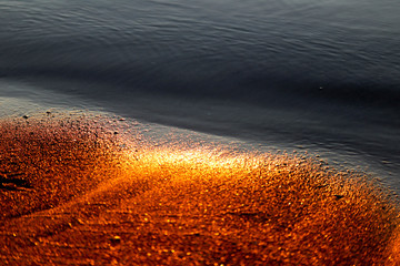 Shining golden sand and water