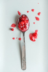 Teaspoon with fresh red currant jam and splashes