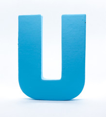 An U of blue painted wood on a white background